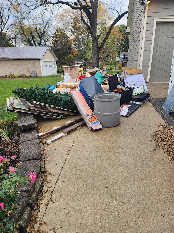 Dumpster being loaded with debris for Estate Cleanout Dumpster Rental in Weston Lakes